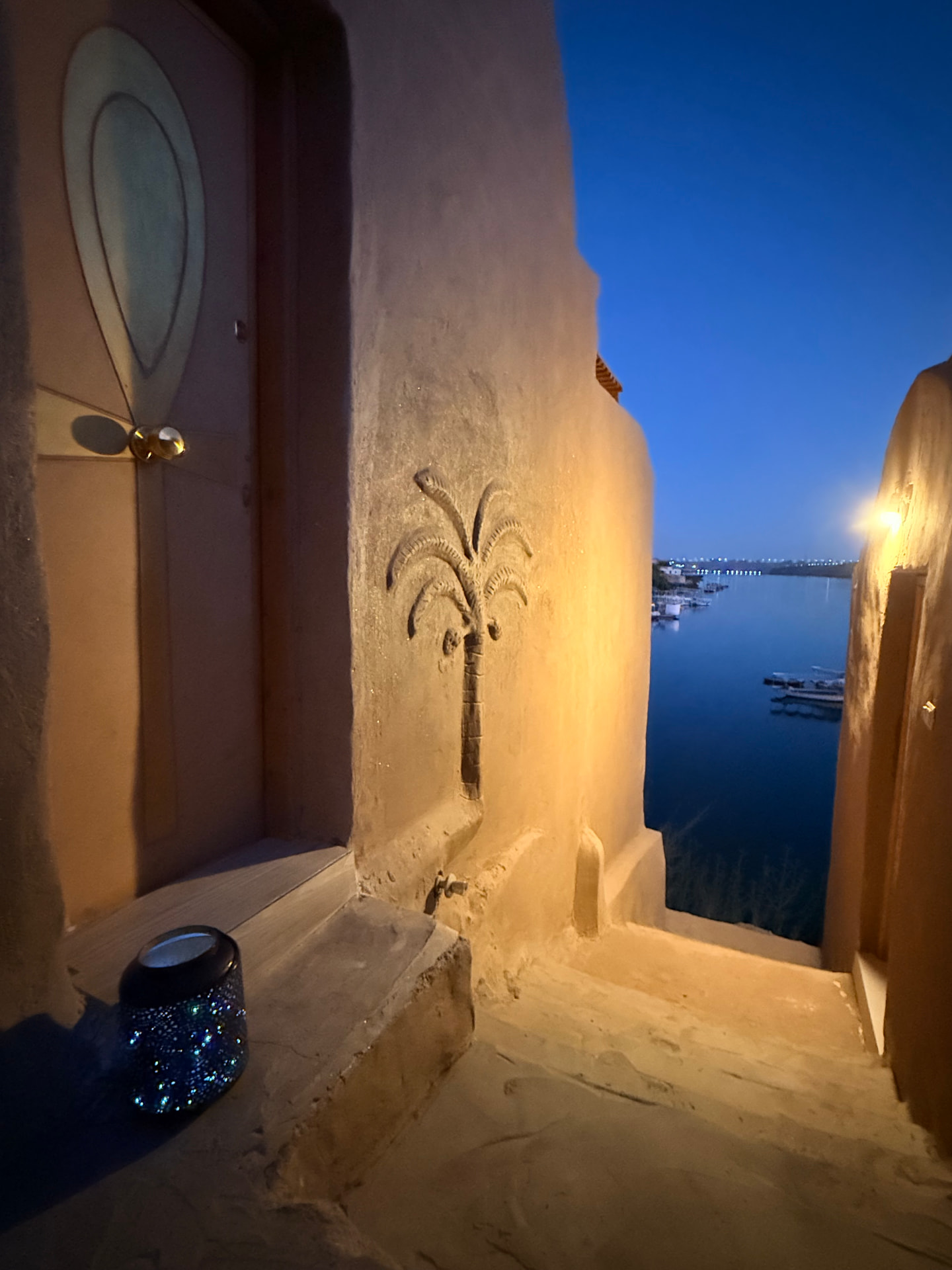 Mud-plastered doorway with carved palm overlooking the Nile at the Love Temple, Nubian Royals Sanctuary, Heisa Island