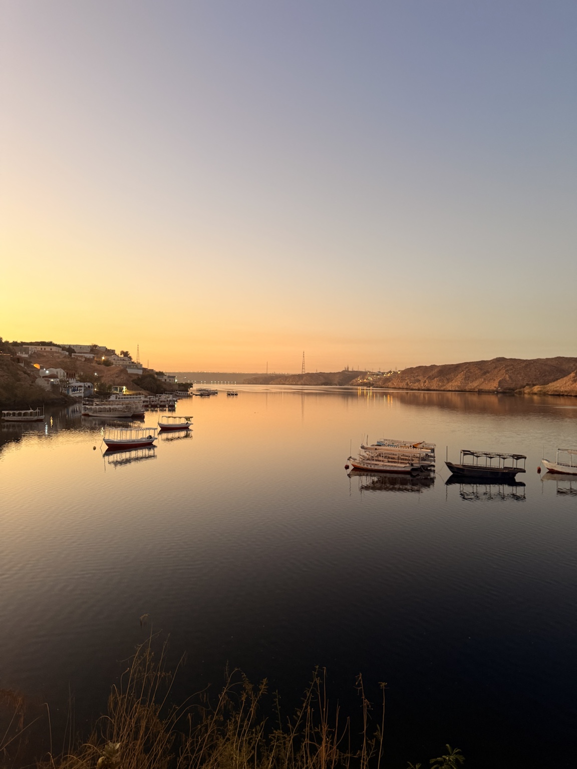 Sunset over the Nile with traditional Nubian boats moored beside Heisa Island, Aswan